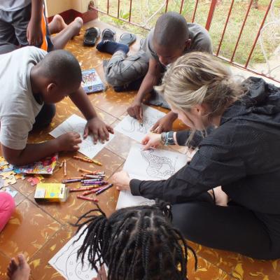 A volunteer coloring books with the children at her Childcare Project A Projects Abroad volunteer on her Spring Break Project coloring books with the children at her Childcare placement in Jamaica